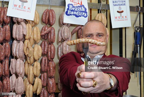 Al Murray attends a photocall to launch British Sausage Week at Allen's of Mayfair, London's oldest butcher shop on November 5, 2012 in London,...