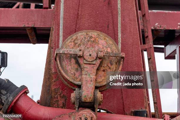 close up of a red steel construction with steel cables and a steel pulley - pulley stock pictures, royalty-free photos & images