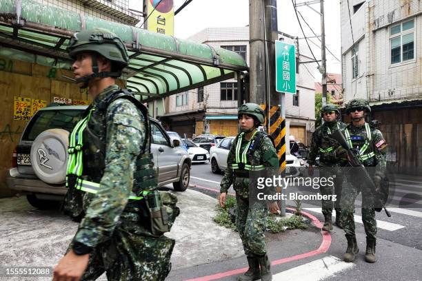 Soldiers march along a street during the Han Kuang military exercise in Taoyuan, Taiwan, on Wednesday, July 26, 2023. China is flexing its military...