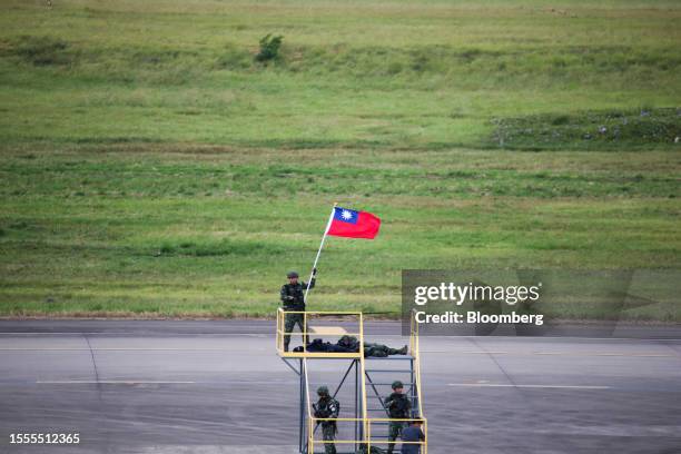 Soldier holds a Taiwanese flag during the Han Kuang military exercise at Taoyuan International Airport in Taoyuan, Taiwan, on Wednesday, July 26,...