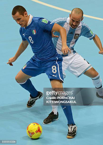Rodolfo Fortino of Italy battles for the ball with Damian Stazzone of Argentian during their first round football match of the FIFA Futsal World Cup...