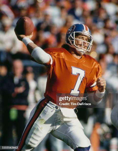 John Elway, Quarterback for the Denver Broncos throws the football downfield during the American Football Conference West Division game against the...