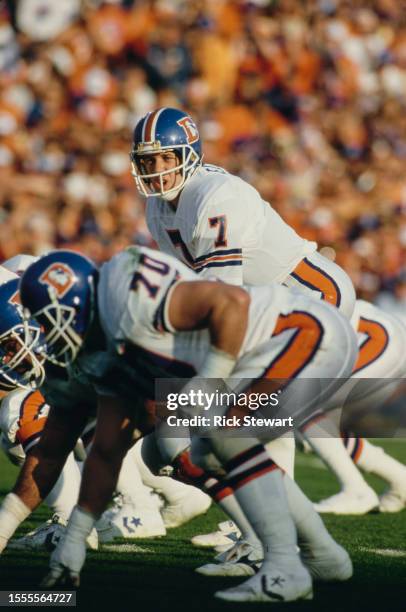 John Elway, Quarterback for the Denver Broncos calls the play on the line of scrimmage during the American Football Conference Championship game...