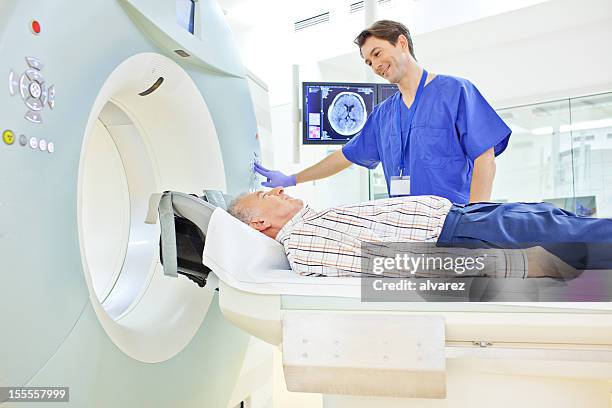 patient at a computer tomography exam - hospital machine stockfoto's en -beelden