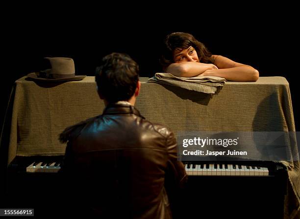 Actress Alicia Gonzalez leans on the piano played by actor Jose Bustos as they chill before getting ready for the 'Tres Anos' theater show, a show...