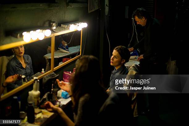 Actor Jose Maya irons his trouwser backstage besides actresses Maria Pastor and Alicia Gonzalez before the 'Tres Anos' theater show, a show that...
