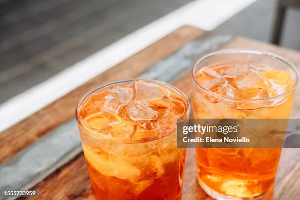 traditional italian cocktail spritz with ice in italian bar, an aperitif in rome, milan venice florence - italian soda stock pictures, royalty-free photos & images