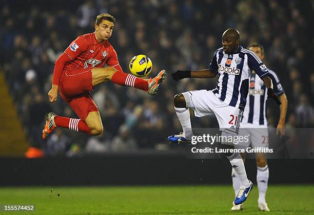 Jay Rodriguez of Southampton competes with Youssuf Mulumbu of West Bromwich Albion during the Barclays Premier League match between West Bromwich...