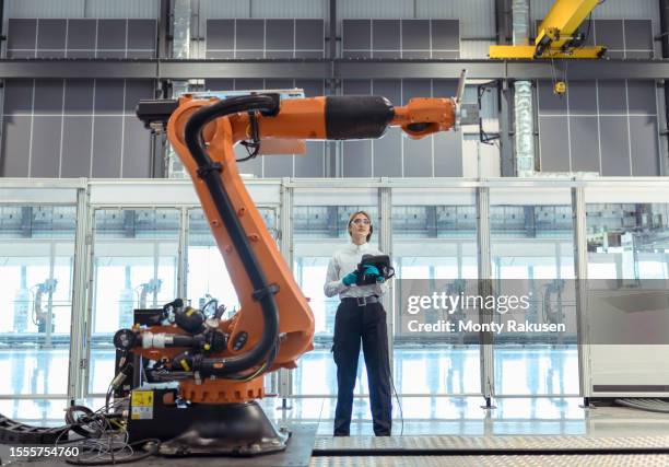 engineer with robot in factory - robotica foto e immagini stock