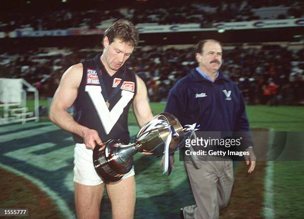 Gavin Brown, Captain of Victoria holds the cup with Leigh Matthews, Coach of Victoria, in the State of Origin match between South Australia and...