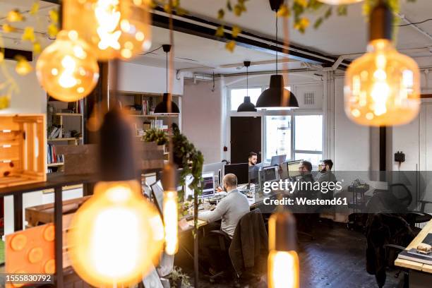 businessmen working on computer at desk in office - light bulb stock pictures, royalty-free photos & images