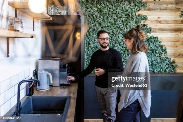 smiling businessman talking to colleague in office cafeteria - department stock pictures, royalty-free photos & images