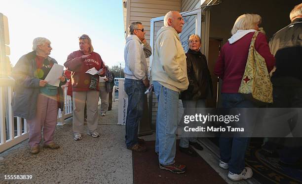 Voters from areas affected by Superstorm Sandy line up to cast their ballots in the 2012 presidential election at the Southern Ocean County Resource...