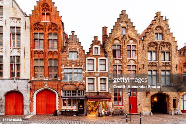 medieval houses standing in a row, bruges, belgium - bruges belgium imagens e fotografias de stock