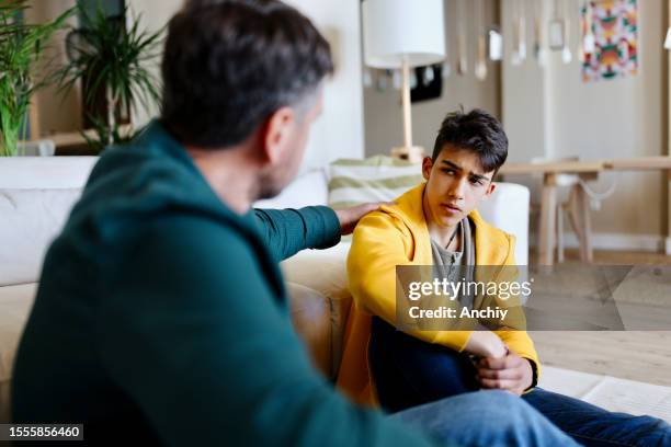father giving advice to his son - cyberbullying parents stock pictures, royalty-free photos & images