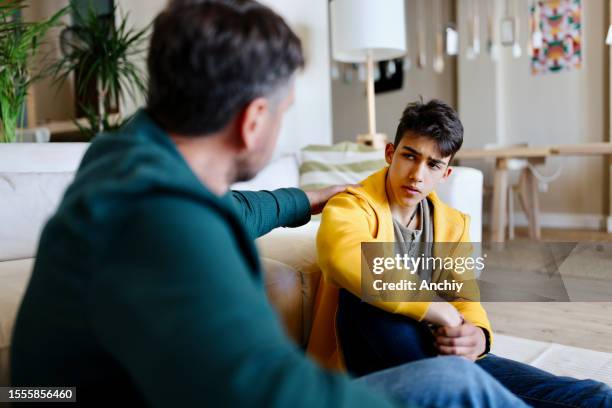 father giving advice to his son - parents and teenagers stock pictures, royalty-free photos & images