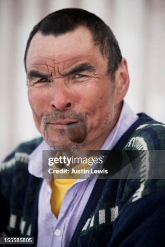 Inuit hunter portrait - smiles and smokes pipe