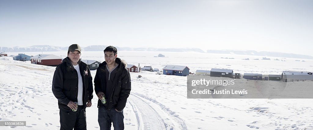 Two Inuit males in front of town-Qaanaaq Greenland