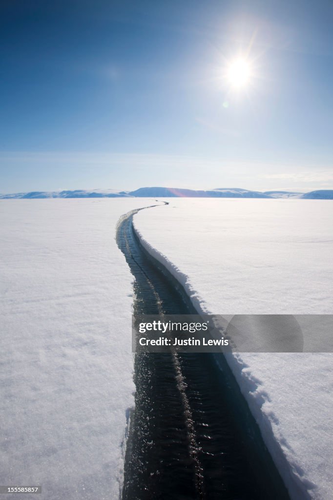 A long crack in the sea ice exposes water below