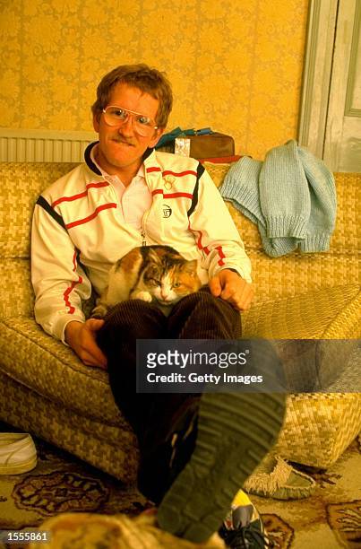 Ski Jumper Eddie Edwards of Great Britain relaxes with his cat during a feature at his home in Cheltenham, England. \ Mandatory Credit: Allsport UK...
