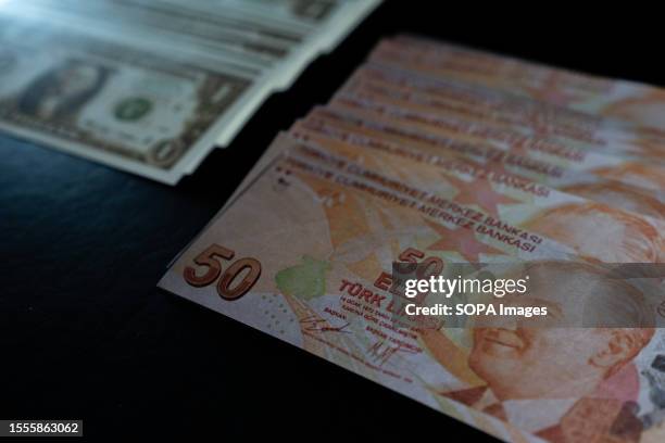 In this photo illustration displays a collection of one dollar and fifty Turkish lira banknotes. In the election that took place on 28 May in Turkey,...