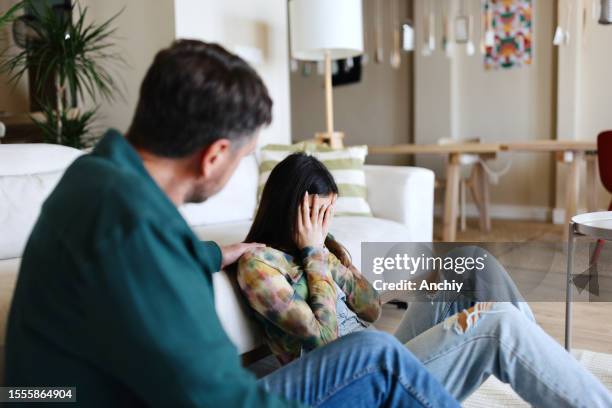 worried daughter talking with her father at home - cyberbullying parents stock pictures, royalty-free photos & images