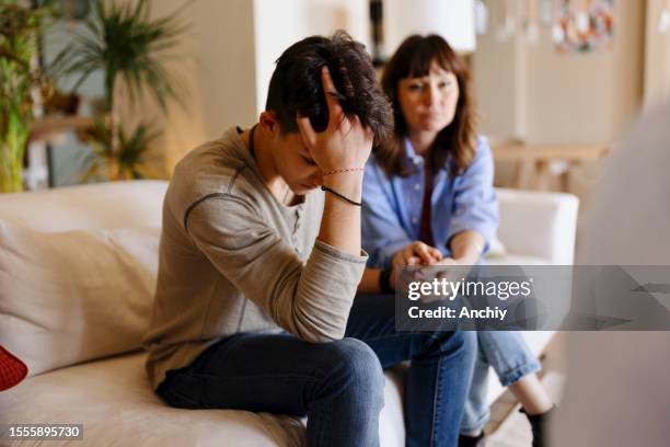 mother and son doing a psychotherapy - sad child and parent stock pictures, royalty-free photos & images