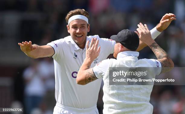 Stuart Broad of England celebrates with Ben Stokes after dismissing Travis Head of Australia and claiming his 600th Test dismissal during the first...