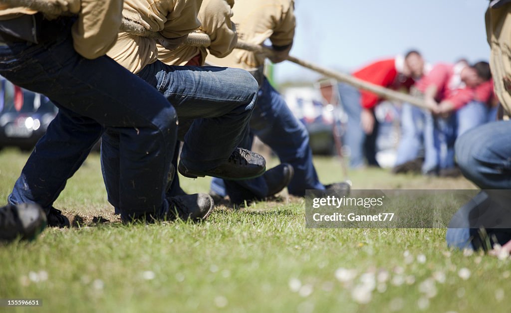 Men's tug of war contest in sunny field