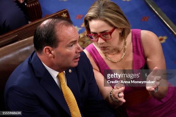 Sen. Kyrsten Sinema talks to Sen. Mike Lee as they wait for an address by Israeli President Isaac Herzog during a joint meeting of the U.S. Congress...
