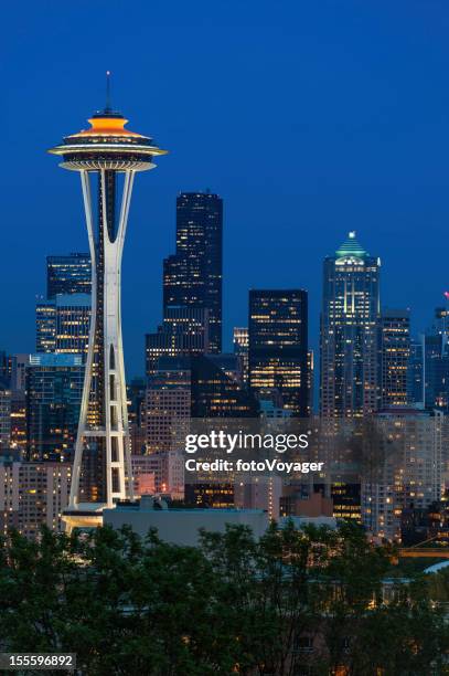 seattle downtown skyline illuminated at night - seattle skyline stock pictures, royalty-free photos & images