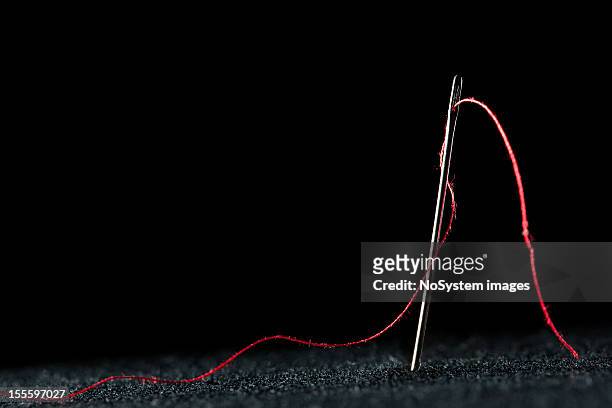 needle and red thread - sewing needle stock pictures, royalty-free photos & images