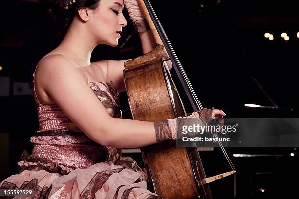 cello playing cellist musician - soloist stock pictures, royalty-free photos & images