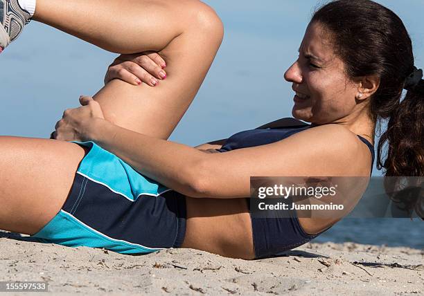 sore muscle/ muscle pain in her hamstrings muscles - calf stock pictures, royalty-free photos & images