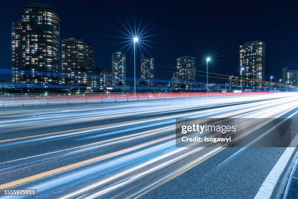 tokyo skyline and light trails against a clear night sky - isogawyi stock pictures, royalty-free photos & images