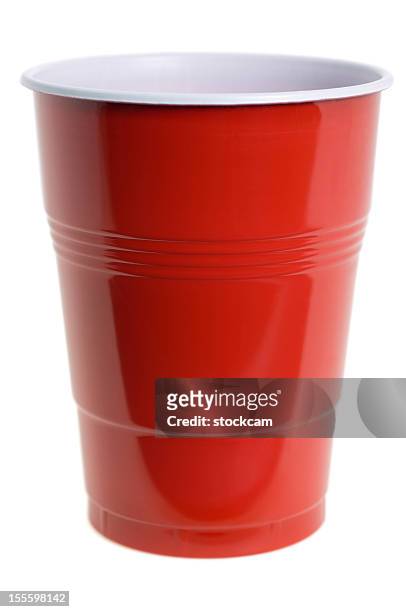 red plastic cup on white background - cup stockfoto's en -beelden