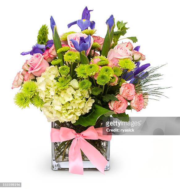 colorful floral bouquet in glass vase with pink ribbon isolated - flower arrangement stock pictures, royalty-free photos & images
