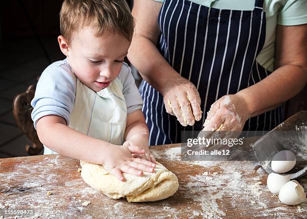 a toddler attempting to knead dough - baking bread stock pictures, royalty-free photos & images