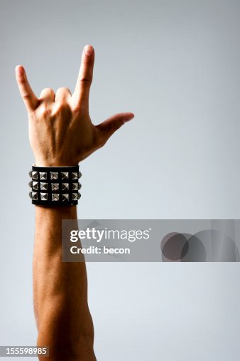 Man in Wristband making Rock & Roll Hand Symbol Man in Wristband making Rock & Roll Hand Symbol