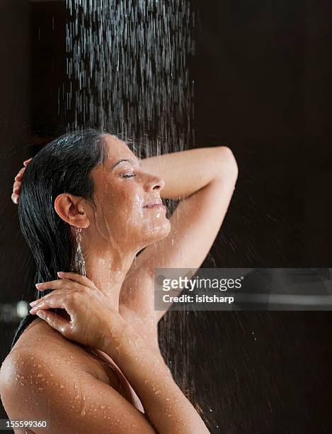 woman in a shower - women taking showers stock pictures, royalty-free photos & images