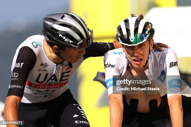 Marc Soler of Spain and Tadej Pogacar of Slovenia and UAE Team Emirates - White Best Young Rider Jersey cross the finish line during the stage...