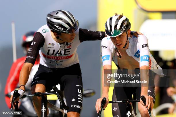 Marc Soler of Spain and Tadej Pogacar of Slovenia and UAE Team Emirates - White Best Young Rider Jersey cross the finish line during the stage...