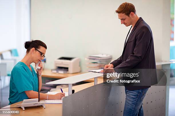 Doctor Check In Checking In Doctors Office Photos and Premium High Res Pictures - Getty ...