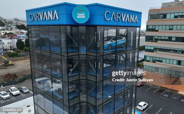 In an aerial view, a sign is posted on the exterior of a Carvana car vending machine on July 19, 2023 in Daly City, California. Shares of used car...