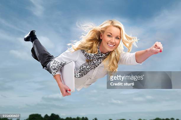 high flying businesswoman - superhero flying stock pictures, royalty-free photos & images