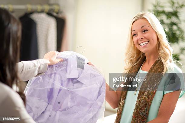 picking up the dry cleaning - dry cleaning stock pictures, royalty-free photos & images