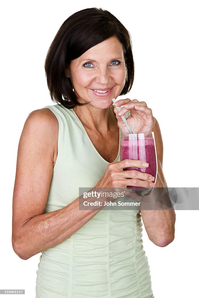 Woman enjoying a fruit smoothie