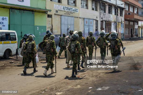 Police officers patrol the streets of Kisumu during the Azimio la Umoja-One Kenya third wave protest over high cost of living on July 19, 2023 in...