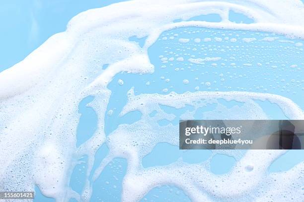 foam on blue motorhood background - spraying water stock pictures, royalty-free photos & images