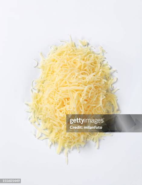 heap of grated cheese isolated on white - grated stock pictures, royalty-free photos & images